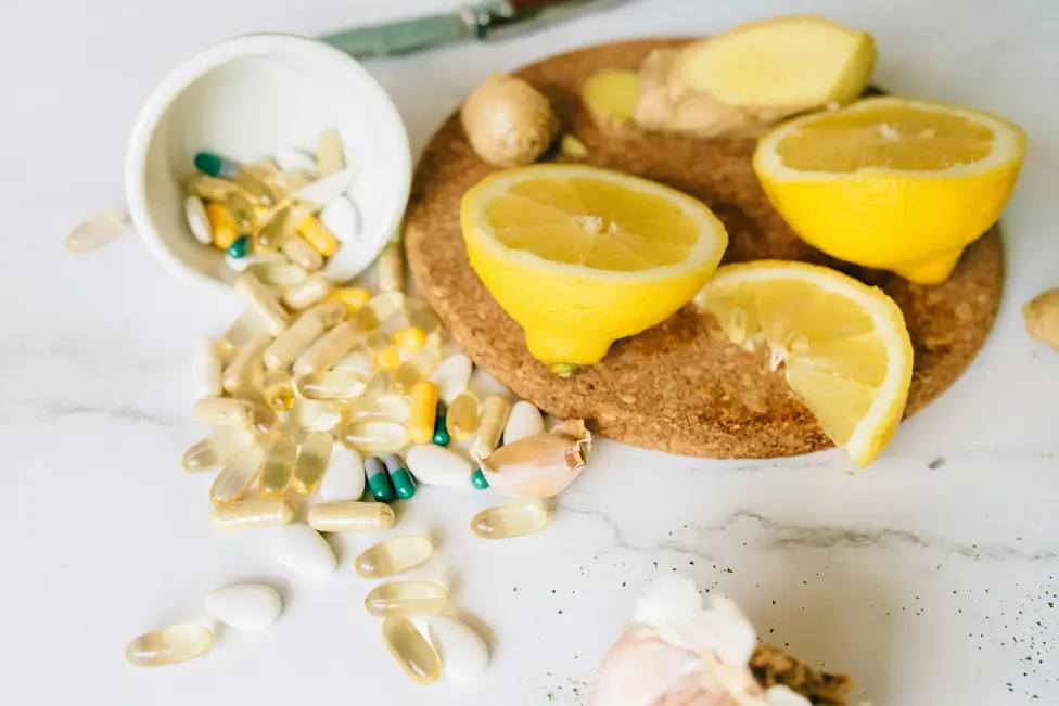 sliced lemons and various supplements on a corkboard symbolizing natural health remedies 1yAzd9JYejMWhmJQODBdaA2