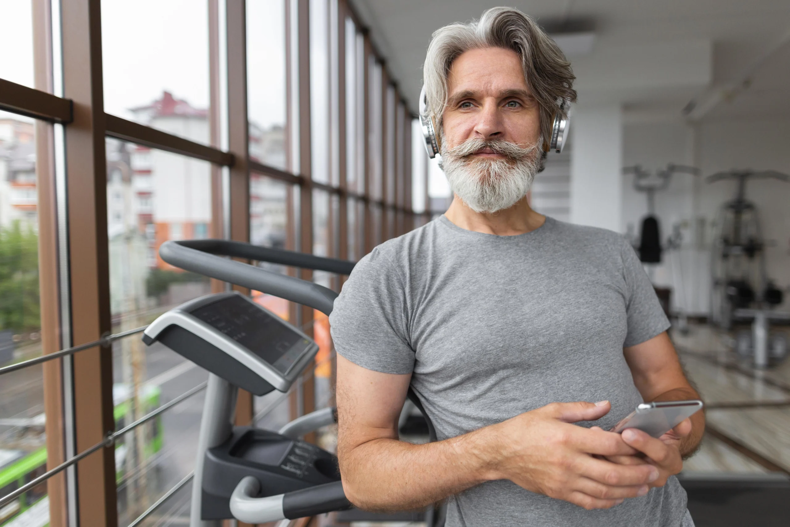 medium shot man with phone gym scaled